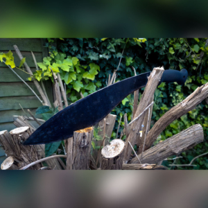 Knives are tools: A Machete embedded in a cut down bush.